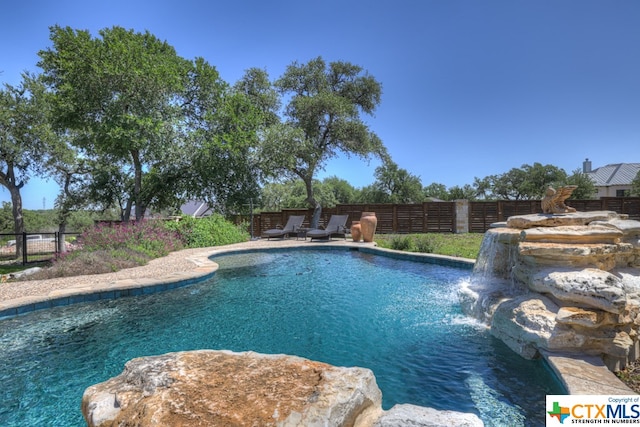 view of pool with pool water feature