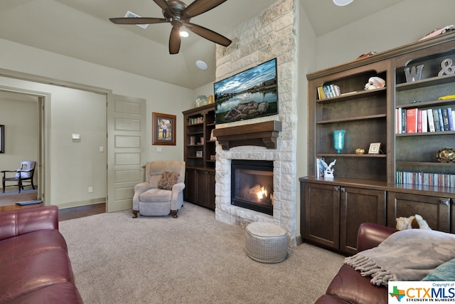 living room with a fireplace, ceiling fan, light carpet, and lofted ceiling