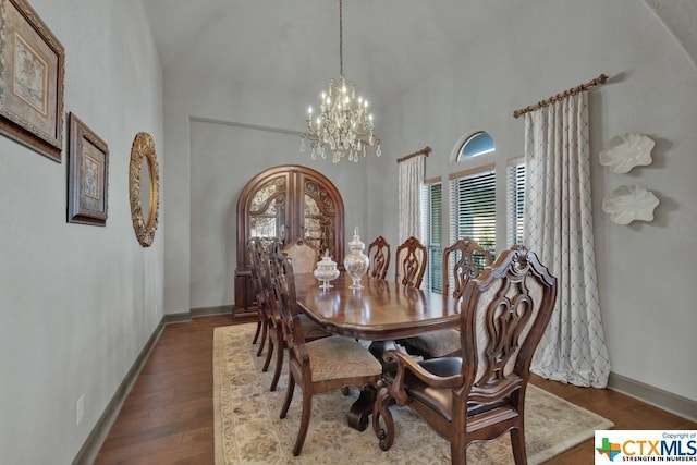 505 Cantera Rdg, New Braunfels, TX 78132 - dining space with a chandelier, high vaulted ceiling, dark wood-style floors, and baseboards