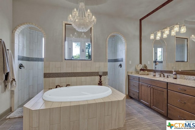 505 Cantera Rdg, New Braunfels, TX 78132 - full bathroom featuring a chandelier, a bath, vanity, and a walk in shower
