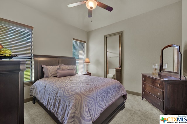 carpeted bedroom featuring ceiling fan and ensuite bath