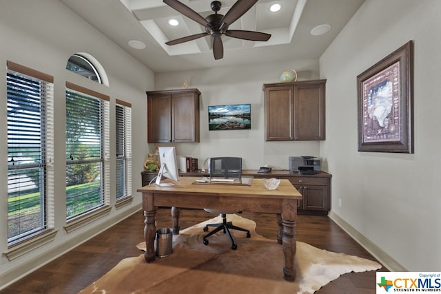 office with ceiling fan, a raised ceiling, and dark hardwood / wood-style flooring