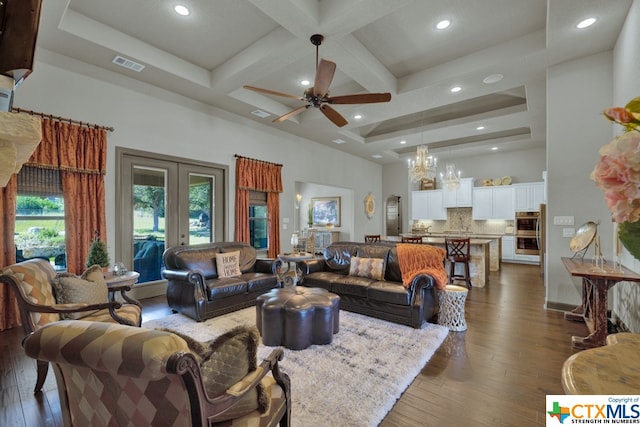 living room with dark hardwood / wood-style flooring, coffered ceiling, beam ceiling, and ceiling fan with notable chandelier