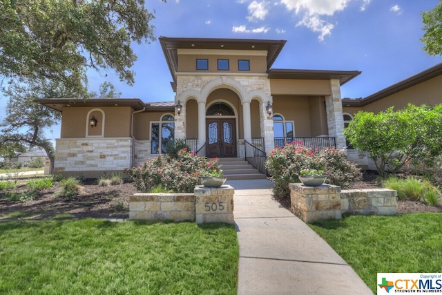 505 Cantera Rdg, New Braunfels, TX 78132 - view of front of home with stone siding, french doors, stucco siding, and a front lawn