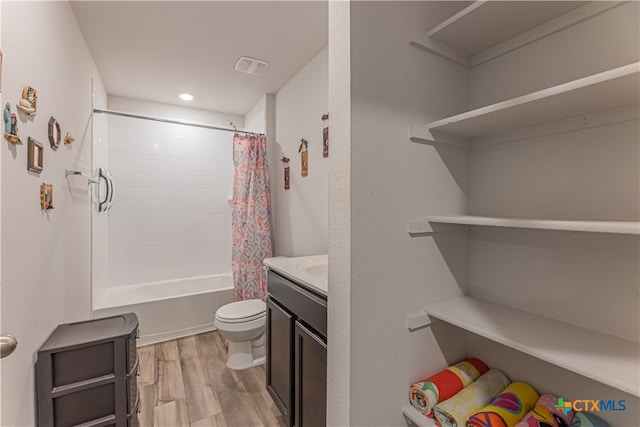 full bathroom with wood-type flooring, vanity, toilet, and shower / bathtub combination with curtain