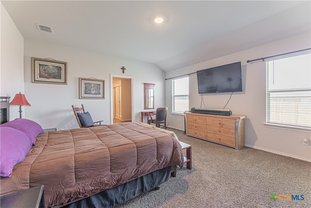 carpeted bedroom with multiple windows and vaulted ceiling