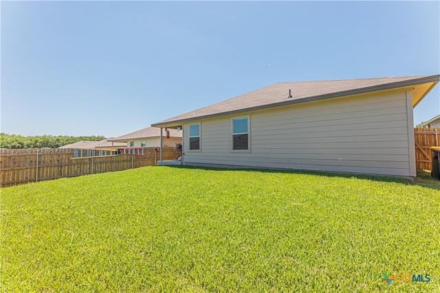 back of house featuring a yard