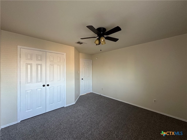 unfurnished bedroom with ceiling fan, a closet, and dark carpet