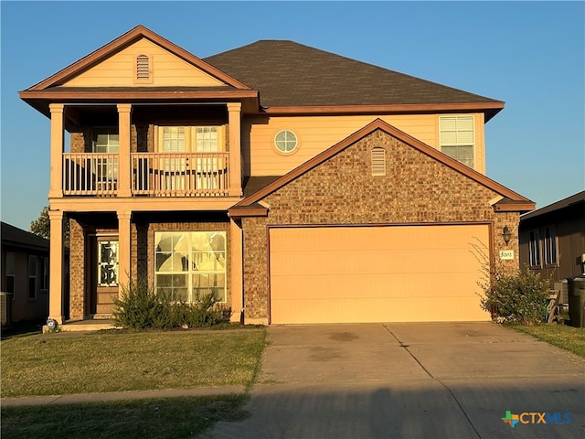 view of front of home featuring a garage, a front yard, and a porch