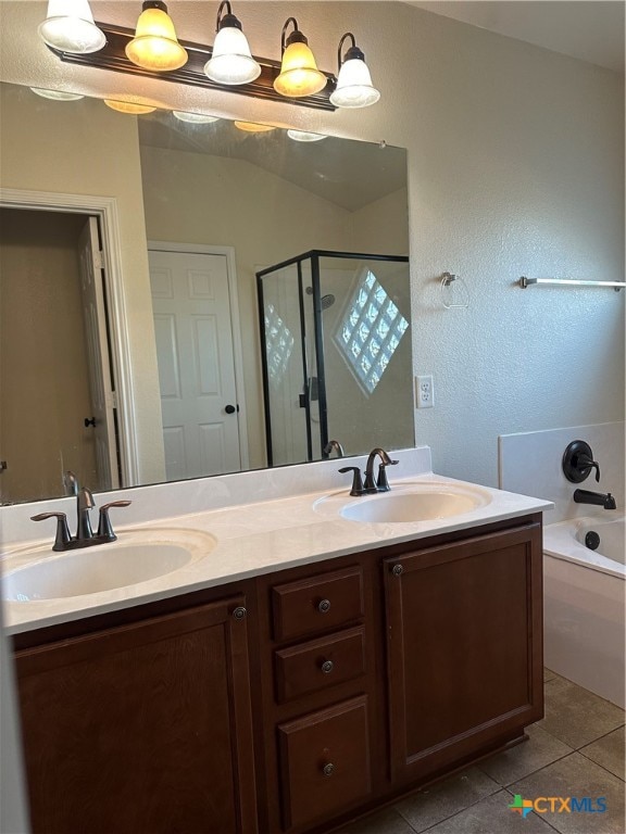 bathroom featuring vanity, tile patterned flooring, and separate shower and tub