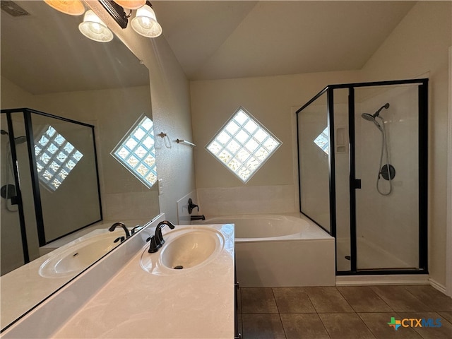 bathroom featuring vanity, independent shower and bath, lofted ceiling, and tile patterned flooring