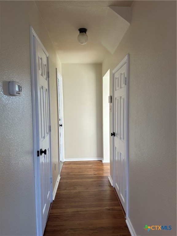 hall with dark hardwood / wood-style flooring