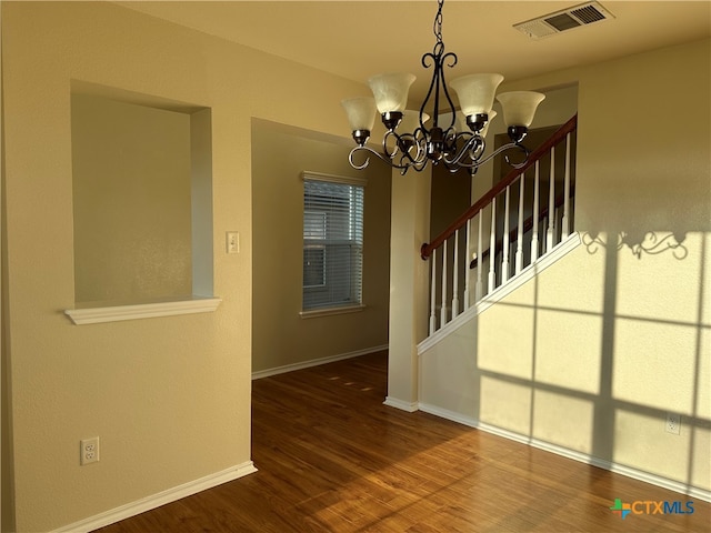 interior space featuring hardwood / wood-style flooring and a chandelier