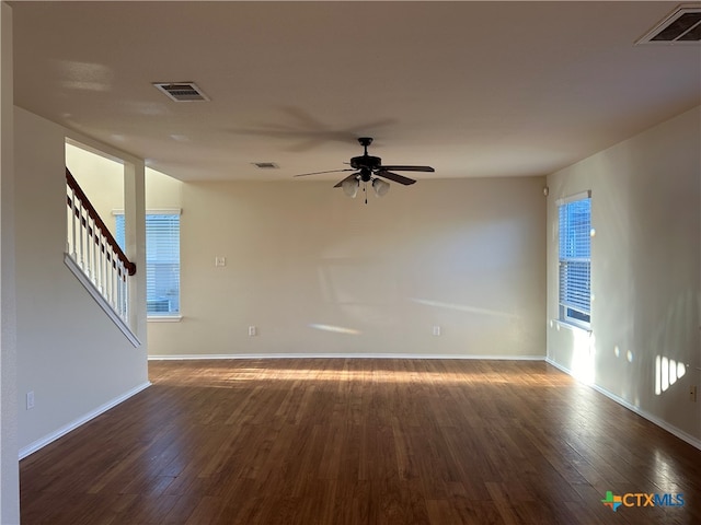 unfurnished room with ceiling fan and dark hardwood / wood-style floors