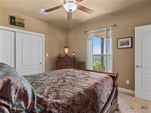 bedroom featuring light carpet, a closet, and ceiling fan