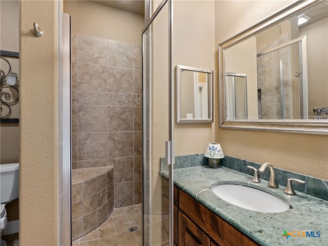 bathroom with vanity, toilet, and an enclosed shower