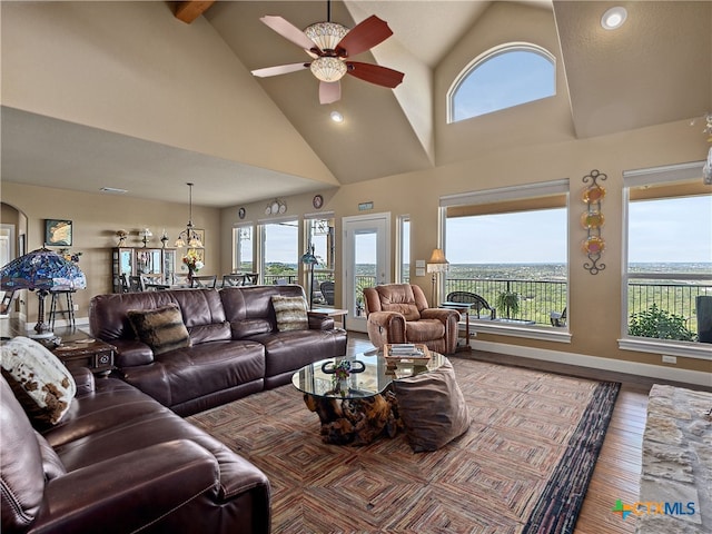 living room featuring a wealth of natural light, ceiling fan, and high vaulted ceiling