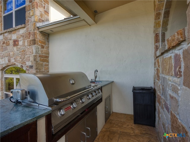 view of patio featuring area for grilling, exterior kitchen, and sink