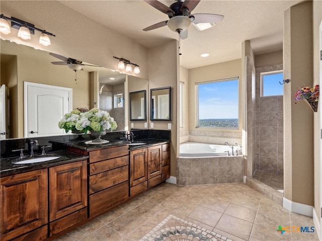 bathroom with tile patterned floors, vanity, ceiling fan, and shower with separate bathtub