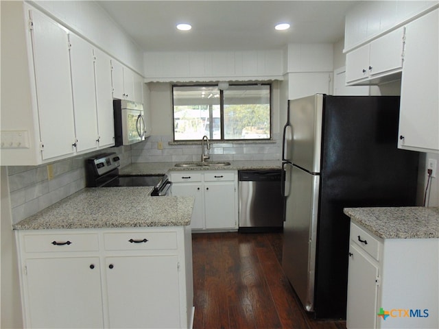 kitchen featuring dark hardwood / wood-style flooring, white cabinetry, sink, and appliances with stainless steel finishes