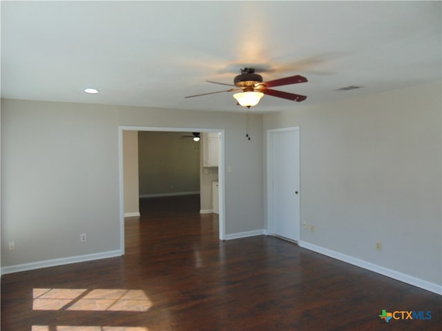 empty room with dark hardwood / wood-style flooring