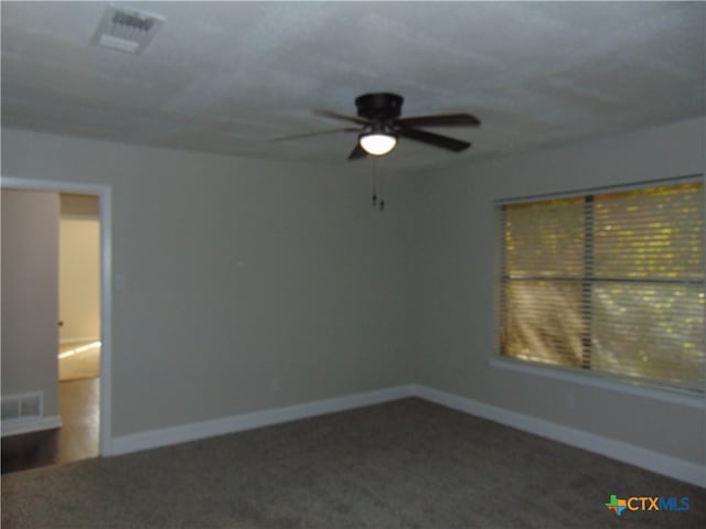 carpeted spare room with ceiling fan