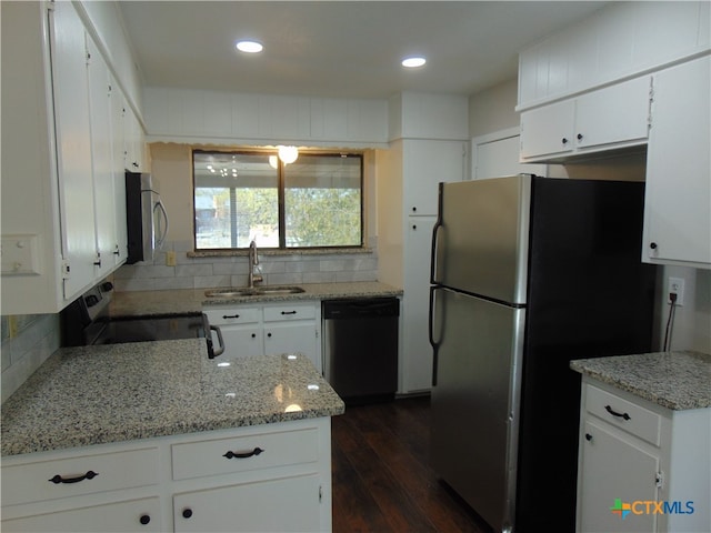 kitchen featuring backsplash, dark wood-type flooring, sink, white cabinetry, and stainless steel appliances