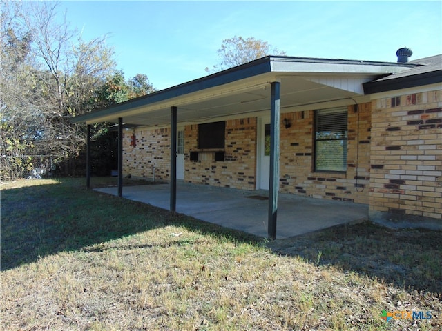 rear view of property with a patio area and a yard