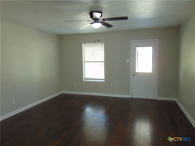 unfurnished room featuring ceiling fan and dark hardwood / wood-style flooring