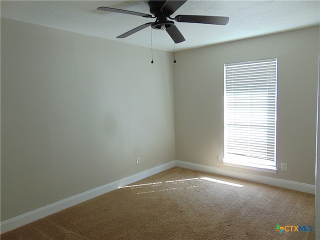 carpeted empty room featuring ceiling fan