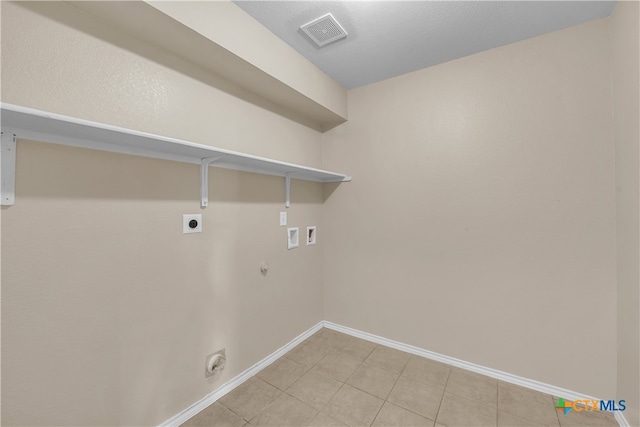 clothes washing area featuring hookup for an electric dryer, washer hookup, light tile patterned floors, and hookup for a gas dryer