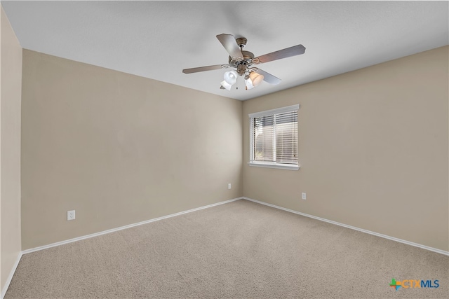 carpeted spare room with ceiling fan