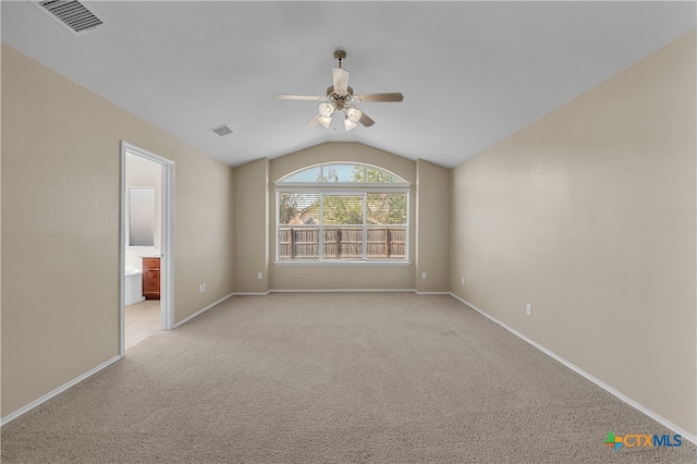 unfurnished room with lofted ceiling, light carpet, and ceiling fan