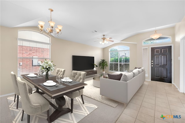 living room featuring ceiling fan with notable chandelier, light tile patterned floors, and vaulted ceiling