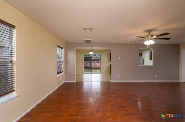 spare room with ceiling fan and dark hardwood / wood-style floors