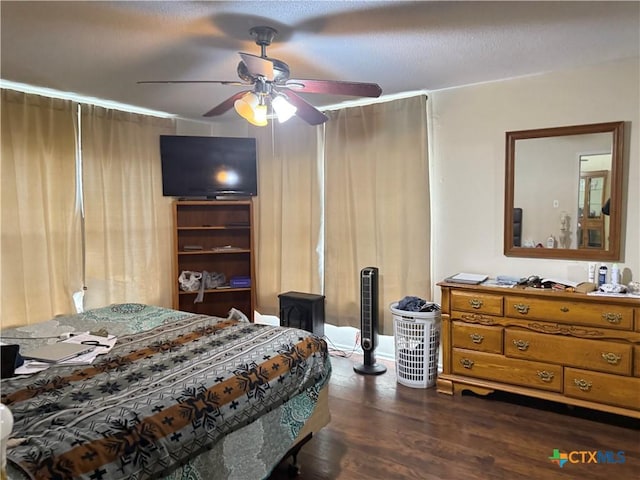bedroom featuring a ceiling fan and dark wood-style flooring