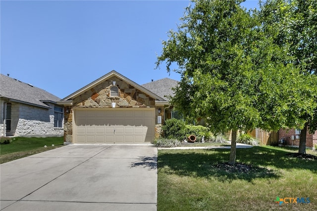 view of front of property featuring a garage and a front yard