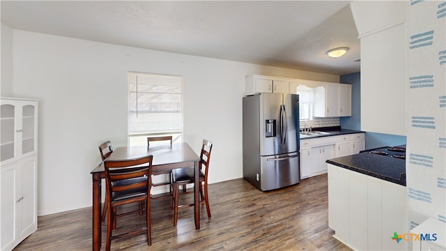 kitchen featuring white cabinetry, stainless steel fridge, sink, and dark hardwood / wood-style floors