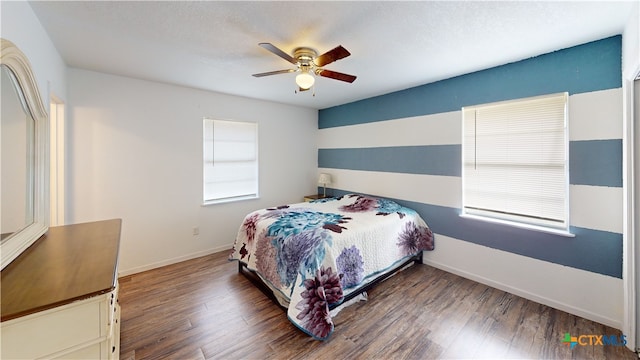 bedroom featuring ceiling fan and dark hardwood / wood-style flooring