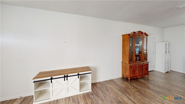 interior space with dark hardwood / wood-style flooring and a textured ceiling