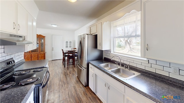 kitchen featuring wood-type flooring, sink, white cabinetry, and stainless steel appliances