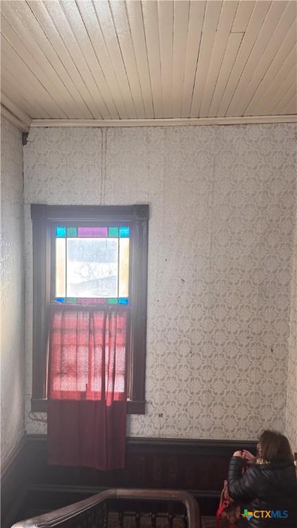 interior details featuring wood ceiling and crown molding