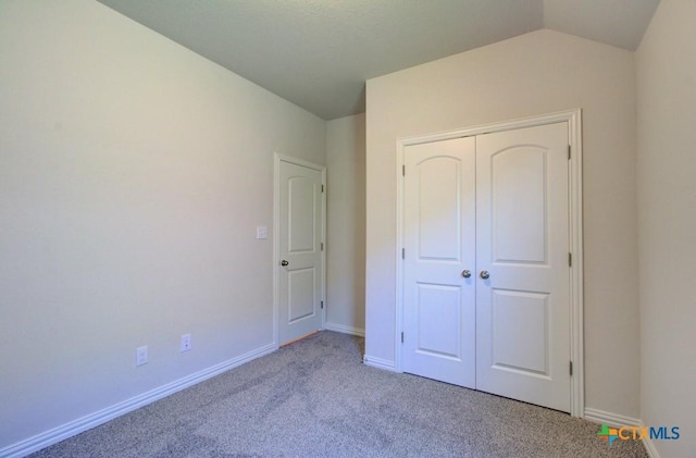 810 Saltbush St, New Braunfels, TX 78130 - unfurnished bedroom with carpet, vaulted ceiling, and a closet