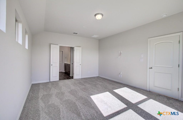810 Saltbush St, New Braunfels, TX 78130 - unfurnished bedroom featuring carpet floors, vaulted ceiling, and connected bathroom