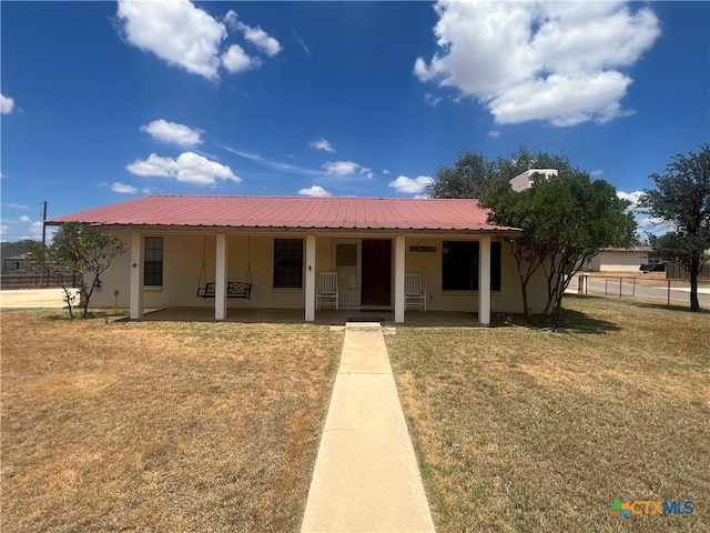 1102 Crockett, Cotulla, TX 78014 - view of front of home featuring stucco siding, metal roof, and a porch