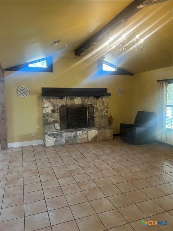 1102 Crockett, Cotulla, TX 78014 - unfurnished living room featuring lofted ceiling, tile patterned flooring, a stone fireplace, and baseboards