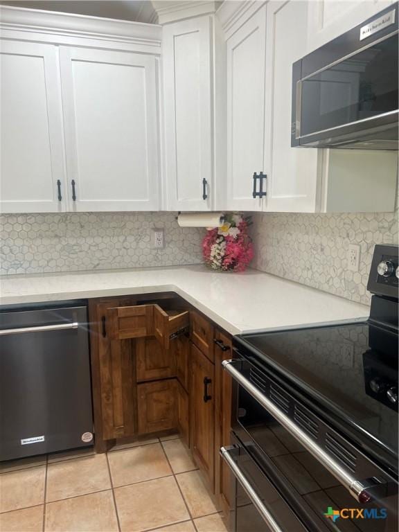 1102 Crockett, Cotulla, TX 78014 - kitchen with range with two ovens, dishwasher, decorative backsplash, and light countertops