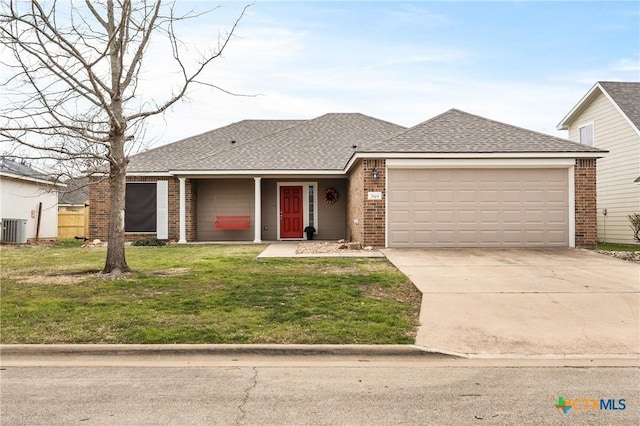 view of front of house featuring brick siding, roof with shingles, concrete driveway, a garage, and a front lawn