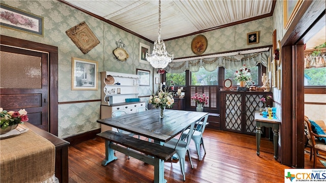 dining room featuring plenty of natural light, an inviting chandelier, and dark hardwood / wood-style flooring