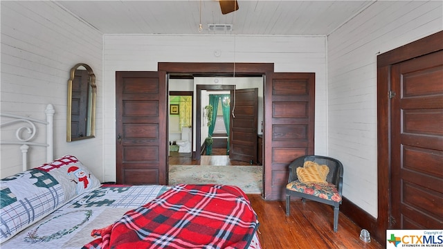 bedroom with ceiling fan and dark hardwood / wood-style floors